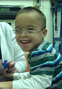 [Image of a child smiling during a CCS assessment]